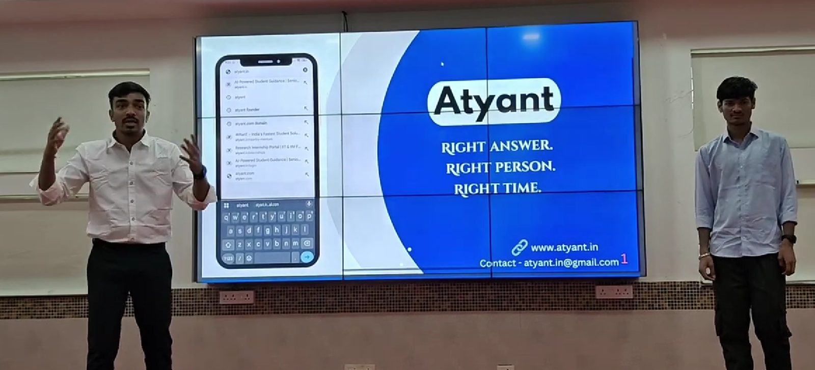 Atyant founders pitching on stage with the slide "Right answer. Right person. Right time."